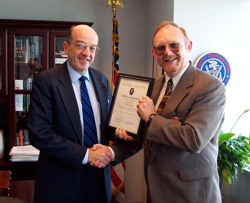 John Jackman presents award to FCC commissioner Michael Copps for working to preserve diversity in media.